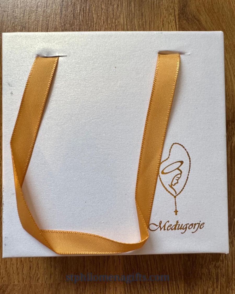 White Medjugorje gift bag with a gold ribbon handle and a gold outline of Our Lady